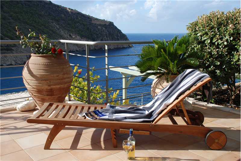 Villa Eleni relaxing on a sun lounger on the pool terrace