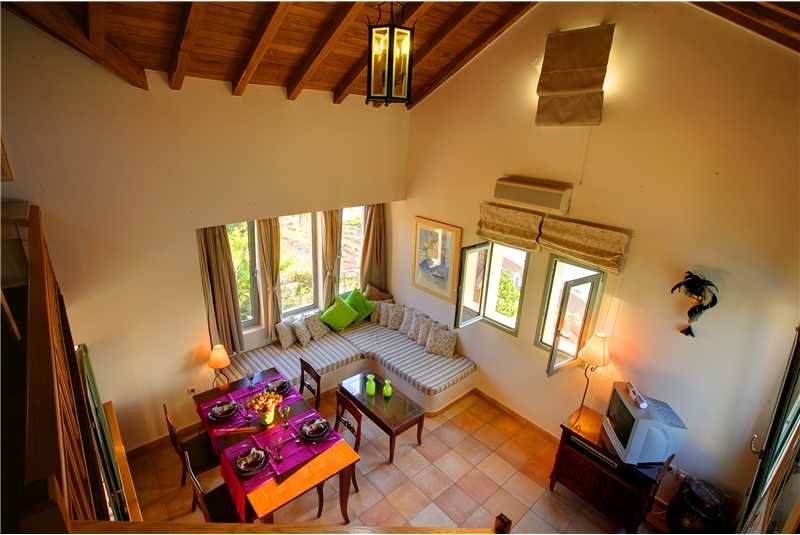 Villa Prikonas lounge and dining room with high wooden ceilings