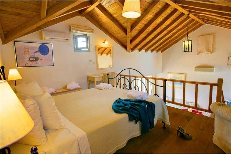 Villa Thea double bedroom with high vaulted wooden ceilings